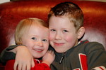 Berkeley and Olivia cuddling in the red leather chair.